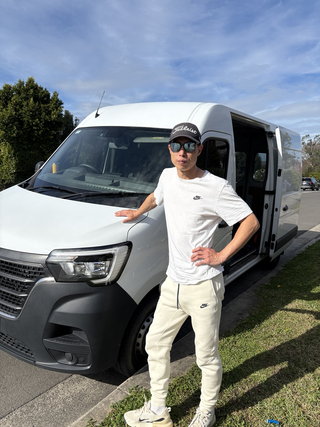 Professional tiler standing next to a van